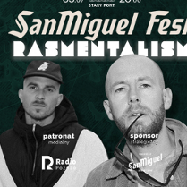 Dwóch mężczyzn, jeden w czapce, drugi ma papierosa w ustach, patrzą przed siebie.