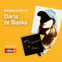 Plakat ze zdjęciem piosenkarki i okładką płyty w prawej części. W części lewej u góry białe napisy na pomarańczowym tle.