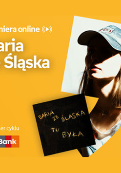 Plakat ze zdjęciem piosenkarki i okładką płyty w prawej części. W części lewej u góry białe napisy na pomarańczowym tle.