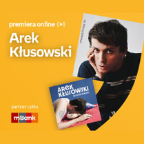 Plakat ze zdjęciem artysty i okładką płyty w prawej części. W części lewej u góry białe napisy na pomarańczowym tle.