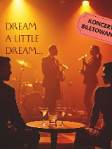 Mężczyzna i kobieta występują na scenie. Na pierwszym planie para siedzi przy stoliku, na którym stoją kieliszki. W tle napis "Dream a little dream".