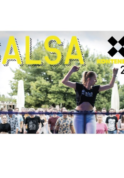 "Salsa w KontenerART 2022". Tańcząca kobieta na scenie, a za nią tłum ludzi.