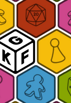 Kolorowe sześciokąty, stykają się ze sobą tworząc obraz, pośrodku jeden biały z literami K, G i F.