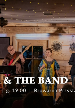 Na scenie zespół składający się z kobiety i czterech mężczyzn. Występują na scenie w drewnianym domu, sufit jest oświetlony lampkami.