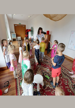 Grupa dzieci z animatorką w bawialni