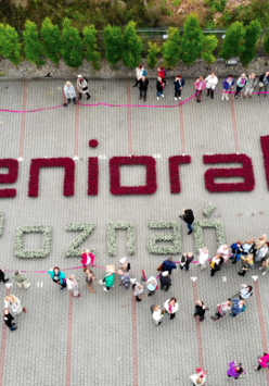 Zdjęcie seniorów wokół napisu "senioralni Poznań".