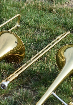 Na zdjęciu instrumenty muzyczne leżące na trawie.