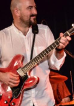 Na zdjęciu Danny Handley z gitarą.