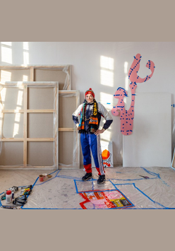 Przemysław Piniak w swojej pracowni. Mężczyzna patrzy prosto w obiektyw.