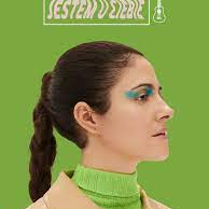 Na zdjęciu artystka na tle zielonego tła.