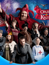 na zdjęciu grupa osób w kostiumach historycznych z różnych okresów, za nimi widoczna największa postać - Stańczyk w czerownym stroju błazna