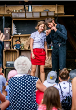 Na zdjęciu znajduje się mężczyzna oraz kobieta na scenie.