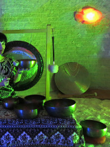 Na zdjęciu obecna jest kobieta, która trzyma misę w grocie solnej. Na zdjęciu est zielone światło.