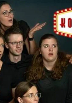 Sześć osób w grupie, obok siebie, wyglądające na zdziwione, patrzące w bok. W górnym, prawym rogu logo Teatru Komedia w Poznaniu.