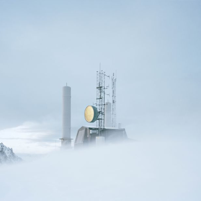 An object with a large, round lamp in a snowy, foggy wasteland.