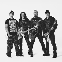 Black and white photo of the Acid Drinkers members. Four men who are standing, three of them are holding electric guitars.