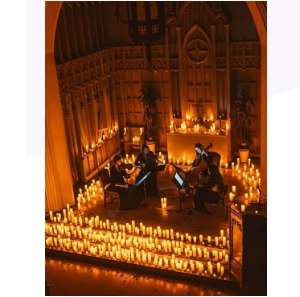 Photo of the stage surrounded by lit candles