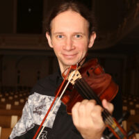 Photo of the artist - Marcin Herman playing the violin