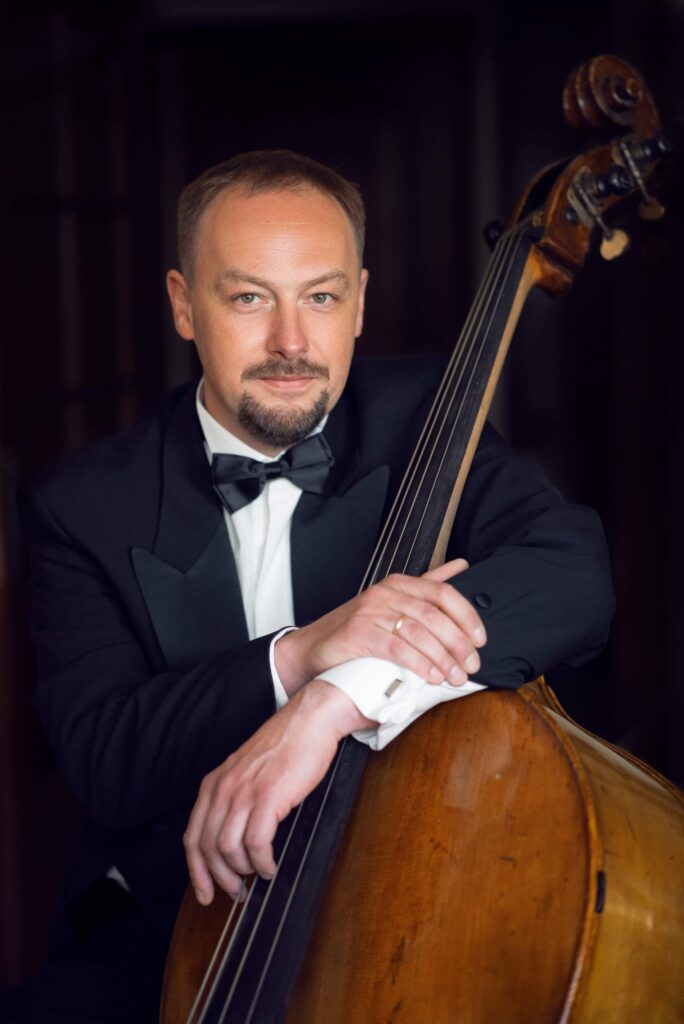 Photo of Szymon Guzowski, one of the concert performers, with his double bass.