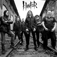 Black and white concert poster with band photo.