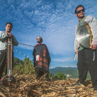 Photo of the band members. Blue sky as a background.