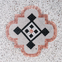 Black and grey photo of a mosaic made of small squares.