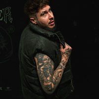 Photo of the young man with numerous tattoos on his arm.