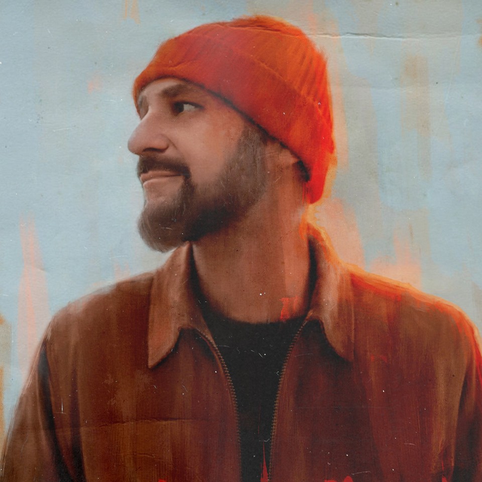 The photo of Skubas - smiling musician, captured in profile, looks into the distance.