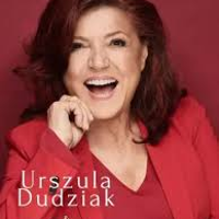 Photo of smiling Urszula Dudziak in red clothes on red background.