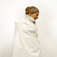 One of the exhibition works: photo of a woman wrapped in white cloth.