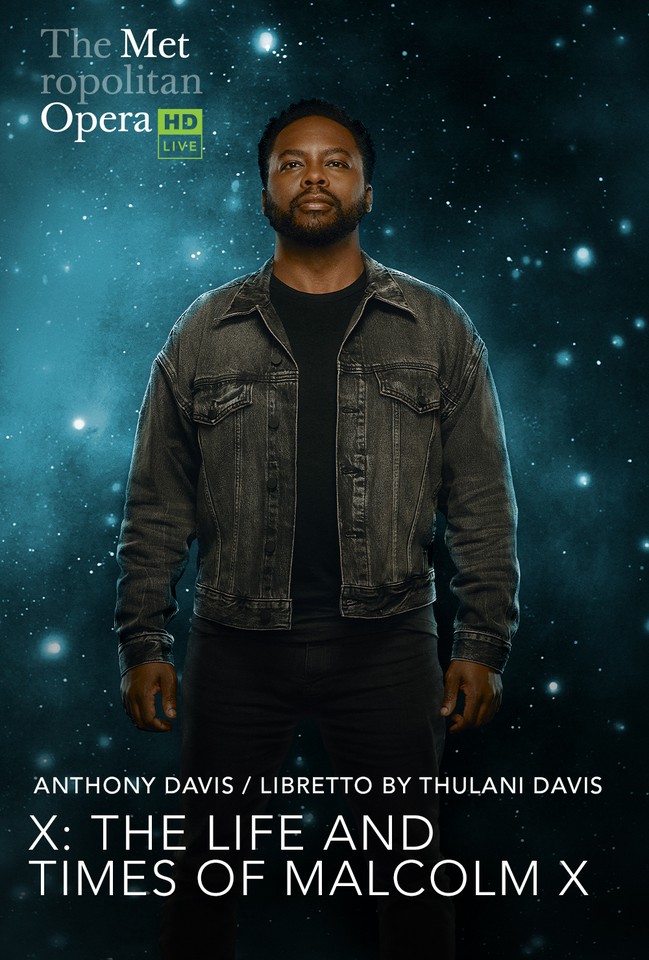 The poster shows a tall man dressed in black T-shirt and a grey denim jacket. Behind him is a starry dark background.
