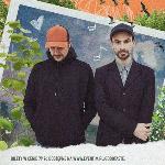 Photo of Fisz Emade - two man, one is looking down, another is looking at the camera. Blue, green and orange background.