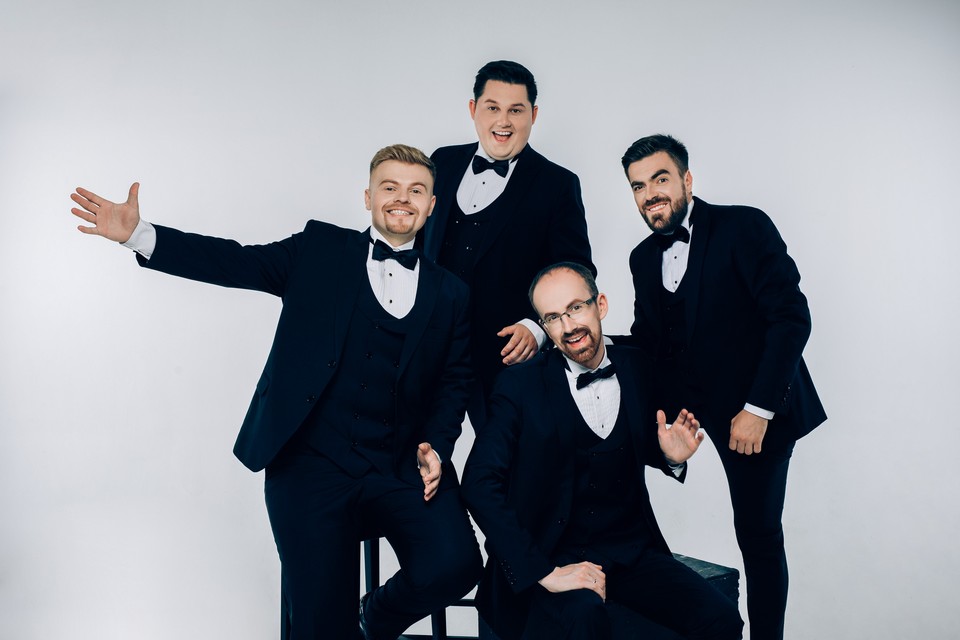 Photo of the band - four men dressed in suits