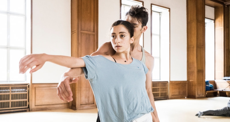 Two dancers - a woman and a man - in a dance pose.