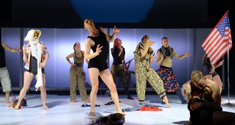 Photo from the performance: several people in various dance poses on the stage.
