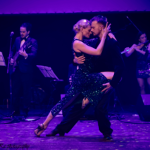 Photo in dark violet colours of a pair of dancers in a dance pose