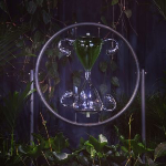One of the works - a dark photo of an hourglass in a circle