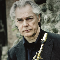 Photo of Jan Garbarek, holding a saxophone in his hands.