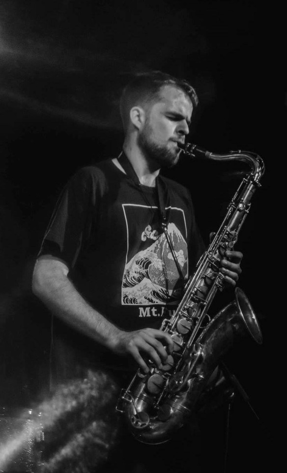 Black and white photo of a man playing the saxophone