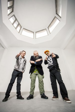 Members of the band - three man standing in white painted room
