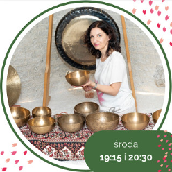 Photo of a woman holding a golden bowl. In front of her a few similar bowls.