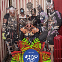 Six black men wearing fancy costumes, masks, and headbands/horns made of various materials.