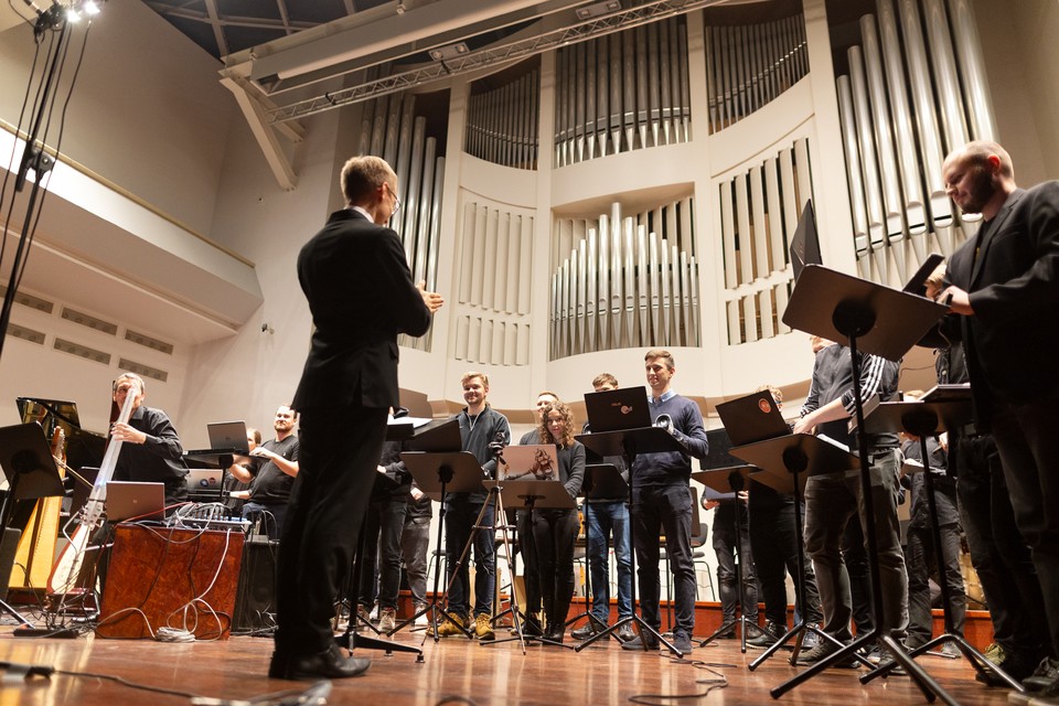 People with laptops on a stage