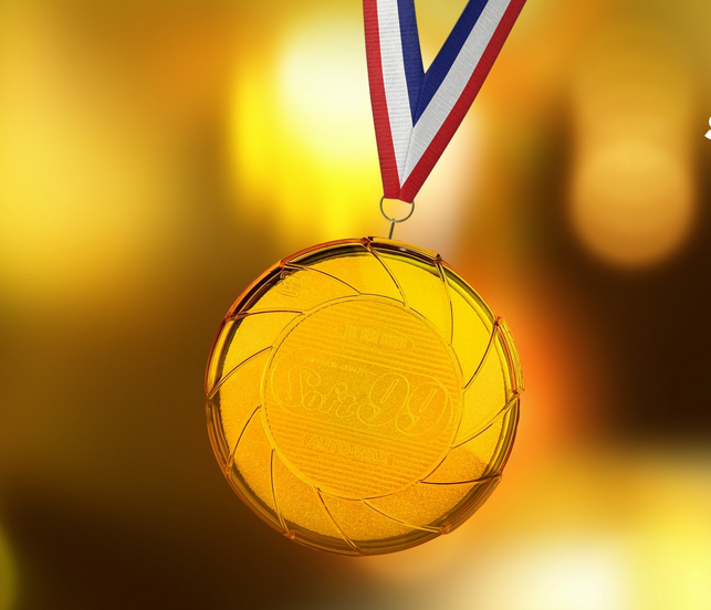 Zdjęcie, na złotym tle złoty medal.