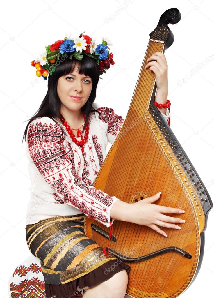 Na zdjęciu kobieta w stroju ludowym grająca na bandurze.